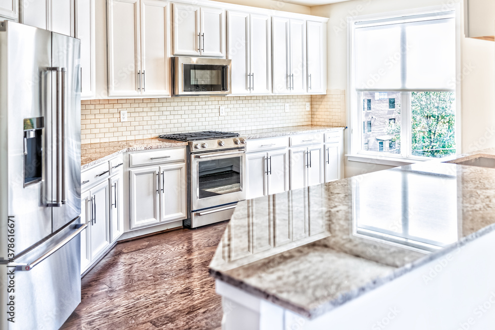 Modern gray, brown kitchen features front with granite