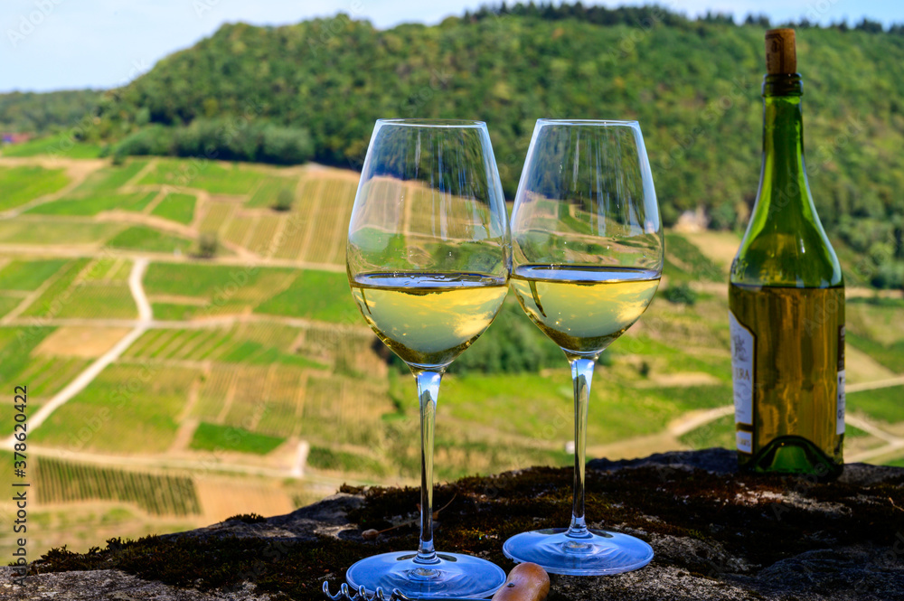 Tasting of white or jaune Jura wine on vineyards near Chateau-Chalon village in Jura region, France Tasting of white or jaune Jura wine on vineyards near Chateau-Chalon village in Jura region, France