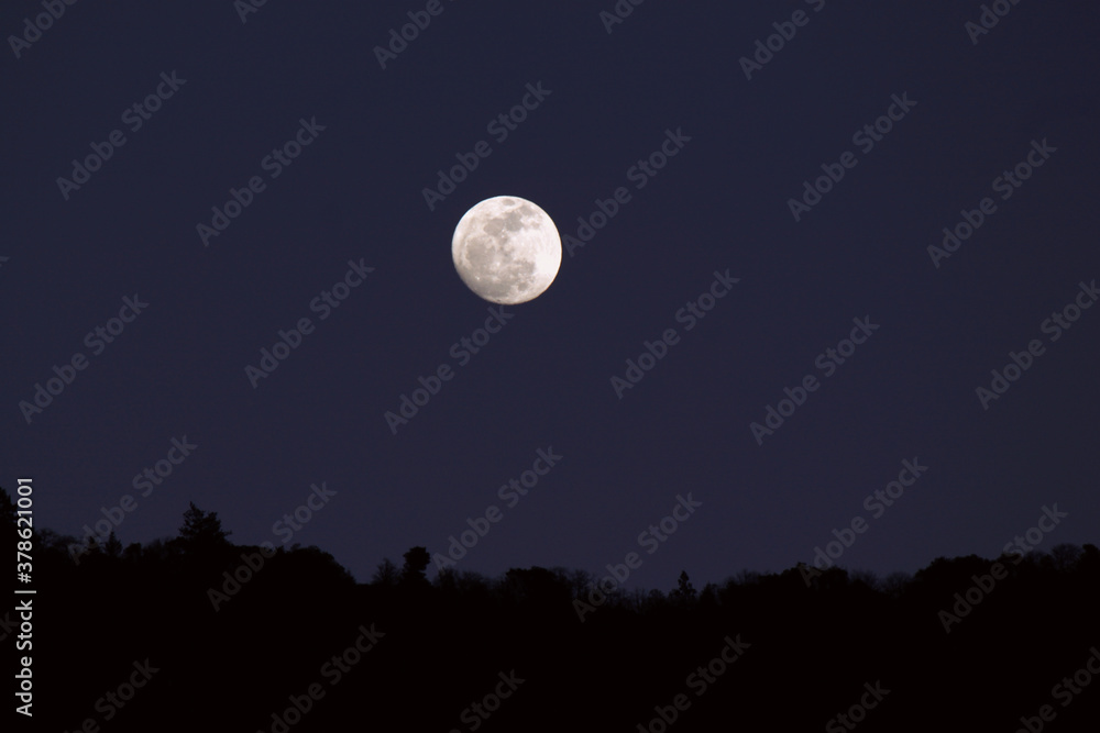 full moon in the night sky at sunset full moon in the night sky at sunset