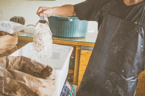 Close up of artisanal sourdough bread production on small bakery. New normal covid-19 economic recovery profession change storytelling concept. photo