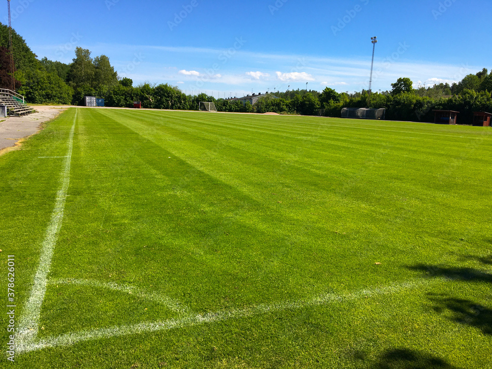 A corner of a soccer field. The white stripes are visible in the green grass. Outside field with nice weather. Järfälla, Stockholm, Sweden. 