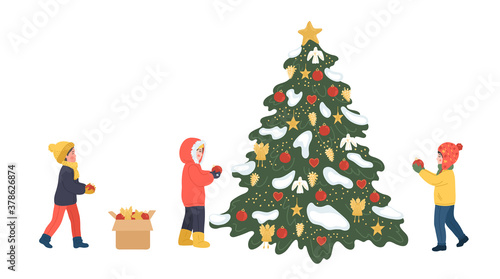 Children decorating Christmas tree outdoors. Group of kids in warm clothes celebrates winter holidays.