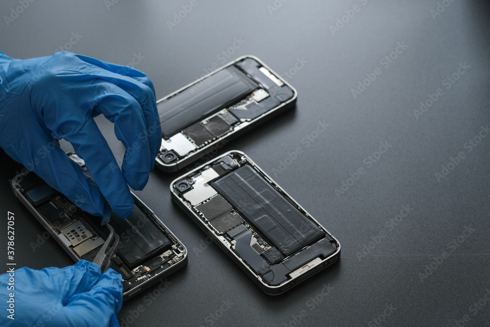 Technician repairing the Cell phone parts and tools for recovery repair  phone smartphone and upgrade mobile technology,the concept of computer  hardware inside. Photos | Adobe Stock
