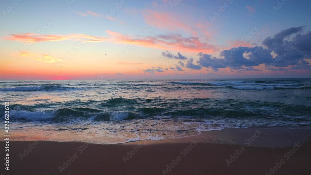 Island beach and beautiful sea sunrise with splashing waves on shore Island beach and beautiful sea sunrise with splashing waves on shore
