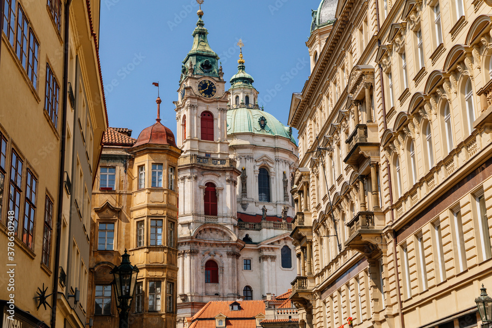 Mostecka Street with a view of the Church of Saint Nicholas, old town with historical buildings, Prague, Czech Republic