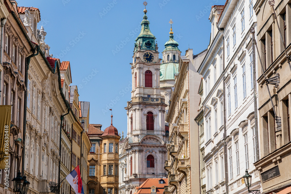 Mostecka Street with a view of the Church of Saint Nicholas, old town with historical buildings, Prague, Czech Republic