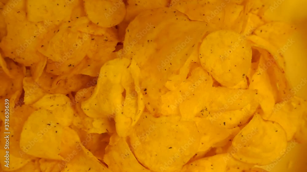 delicious fried potato chips falling from the top down.view from above. delicious fried potato chips falling from the top down.view from above.