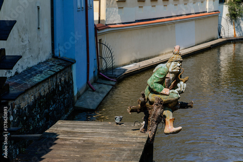 Sculpture of vodyanoy (water demon) near the island of Kampa with the river channel Certovka, Prague, Czech Republic photo