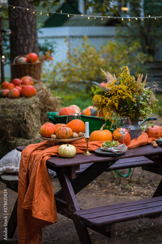 Fall themed holiday table setting arrangement for a seasonal party