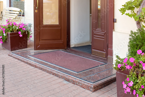 Konstfotografi threshold with mat on entrance door in hotel on facade of building close up architecture details, european cityscape nobody