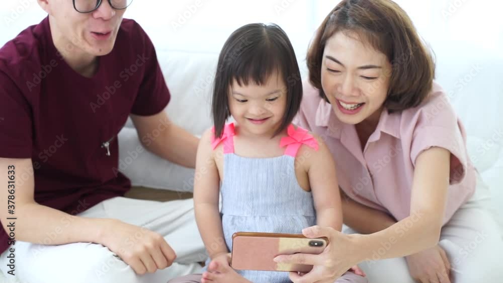 Autism special child girl learning study at home new normal with father and mother in bed room Autism special child girl learning study at home new normal with father and mother in bed room