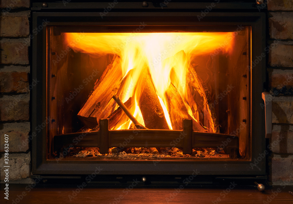 fireplace and fire close view as object or background, brick wall