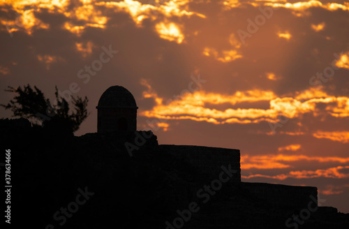 Silhouette of ancient Bahrain Fort watch tower during sunset, Bahrain photo