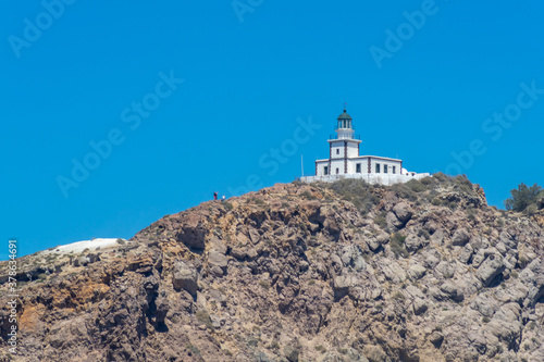 Cliff and lighthouse on the southern of Thira island in Greek Islands on a clear, sunny day with bright, blue sky. Akrotiri, Santorini, Greece. Akrotiri © mathilde