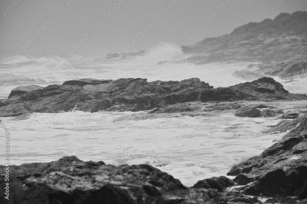 Crashing Waves Among Rocks on Seacoast Crashing Waves Among Rocks on Seacoast