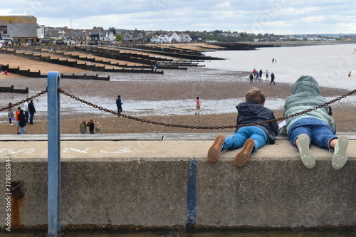 Kids crabbing this summer in Kent England. Cheap hobby which appears to amuse children and adults for hours at the seaside outdoors Bacon ham turkey fish carcass clams works as bait Fresh bait is best