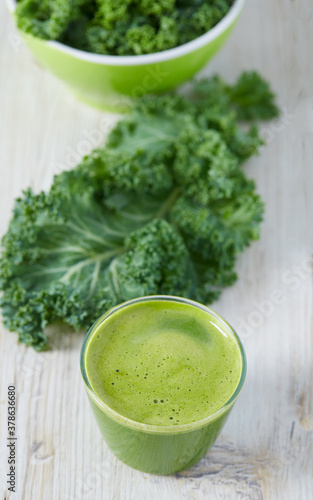 kale juice in a glass on white surface