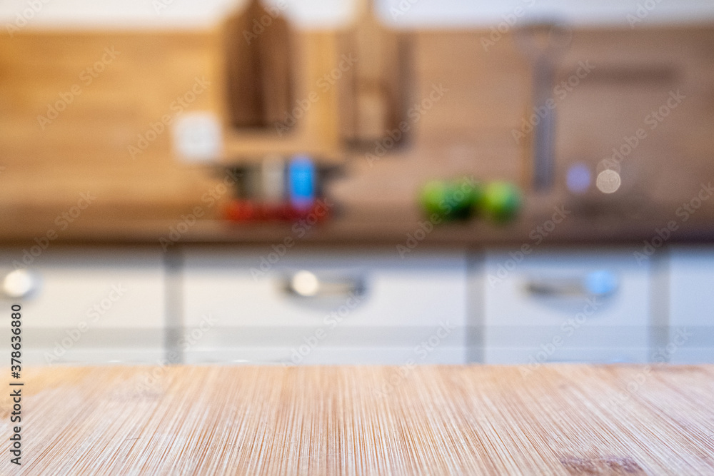 blurred kitchen and a wooden worktop blurred kitchen and a wooden worktop