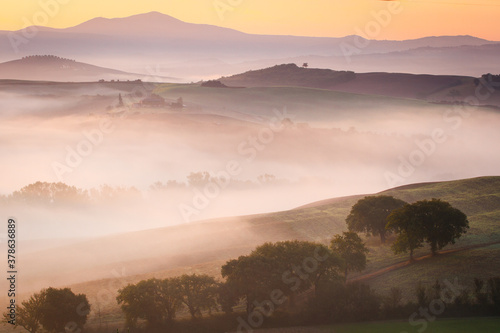 Fototapeta Naklejka Na Ścianę i Meble -  fog over the valley, foggy colorful morning, Tuscany, Italy