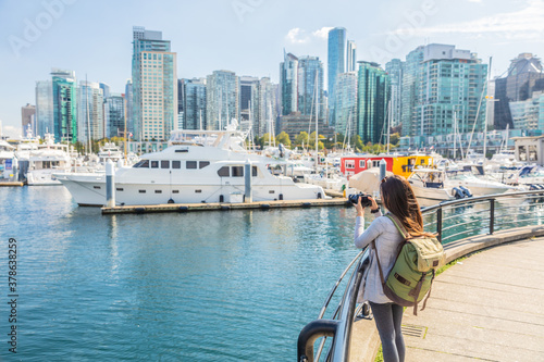 Canvas Print Vancouver Canada tourist woman taking picture with camera at Coal Harbour on summer holidays in canadian city