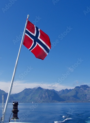 Flag of Norway on sea and mountains background