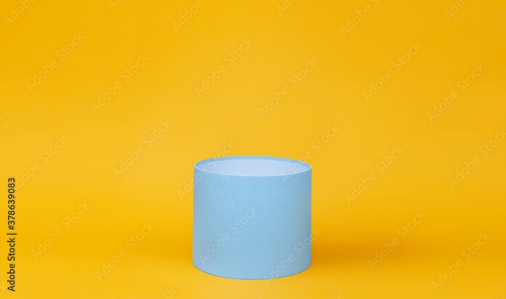 Blue round gift box on yellow background. Blue round gift box on yellow background.