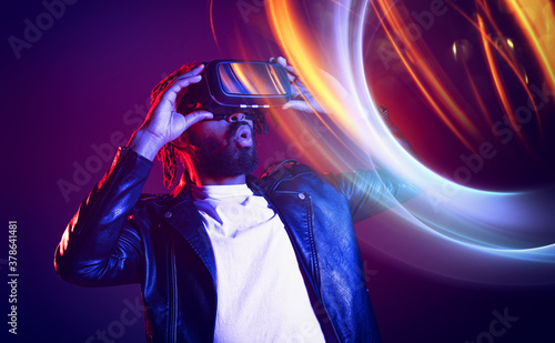 Man with VR glasses play with a virtual videogame