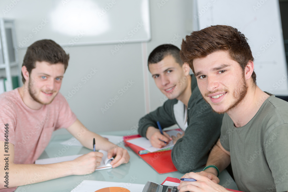 Obraz premium portrait of three male students sat at desk
