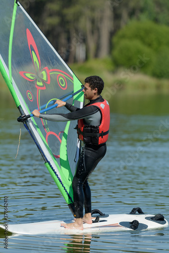 a nice sportman is doing windsurf photo