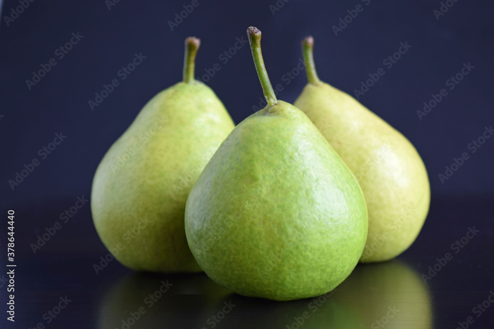 Juicy green pears on a black background.Healthy food. Juicy green pears on a black background.Healthy food.