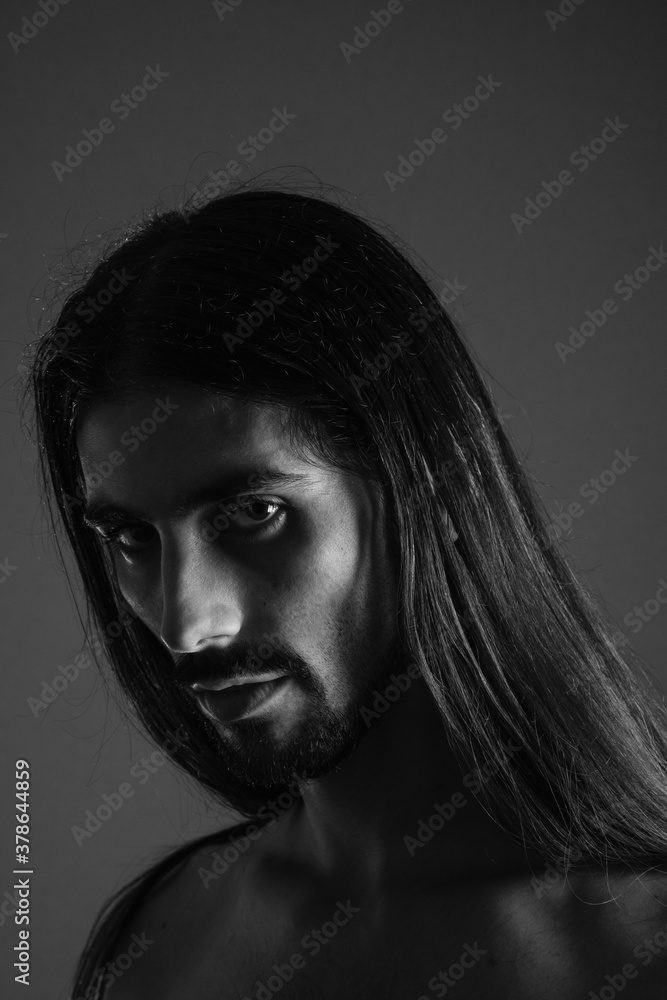Young man with long hair and black and white