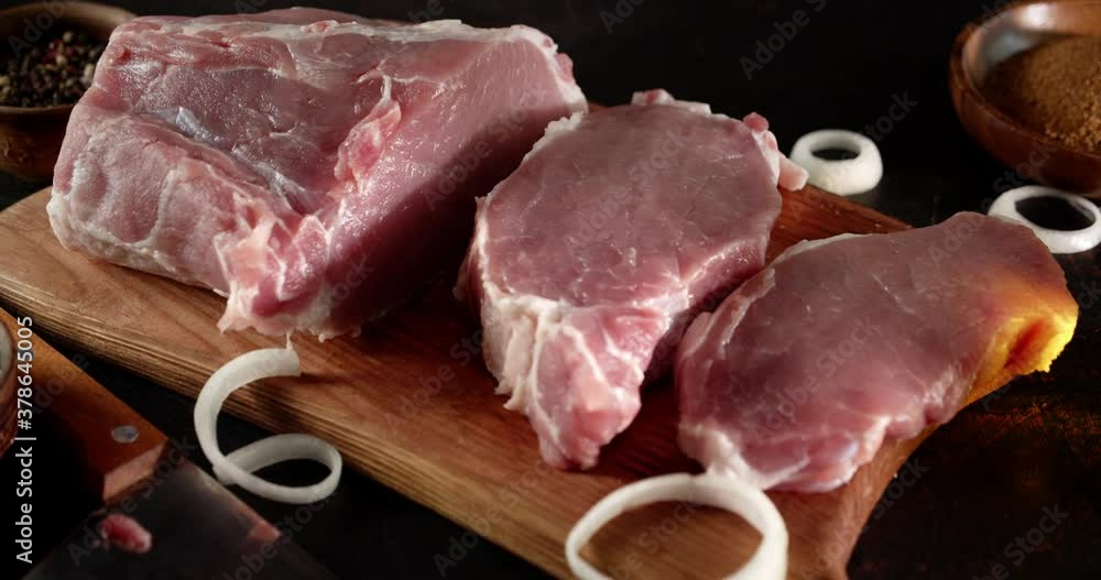 Sliced chunks of raw pork escalope slowly rotate. Sliced chunks of raw pork escalope slowly rotate.