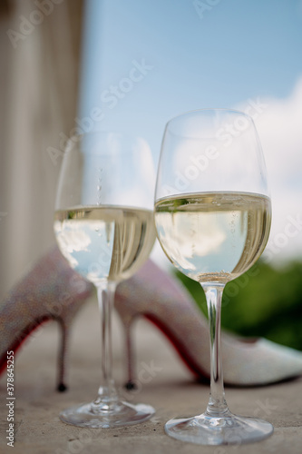 Wedding golden rings in glass of champagne. Symbol of love and marriage.