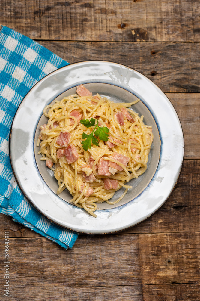 creamy spaghetti pasta with ham on wooden background creamy spaghetti pasta with ham on wooden background