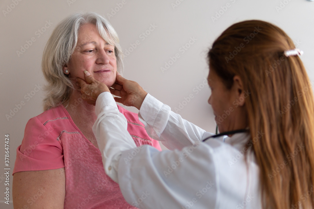 Profile of mature female physician examing patient at medical clinic health, medical, medicine concept.. Profile of mature female physician examing patient at medical clinic health, medical, medicine concept..