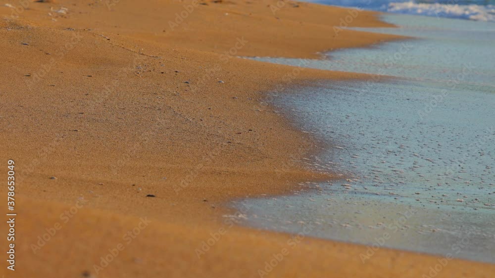 Ocean sea waves splashing on the sandy beach coast Ocean sea waves splashing on the sandy beach coast