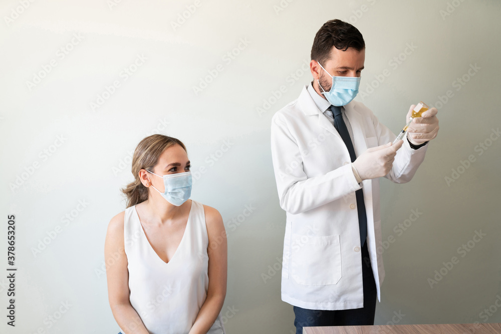 Doctor getting ready to vaccinate a patient