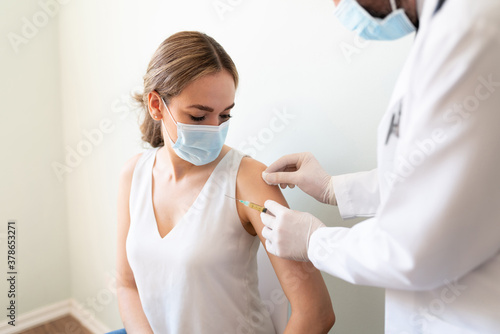 Cleaning up patient's arm for a vaccine photo
