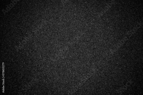 Black asphalt background texture with vignete. Abstract black background