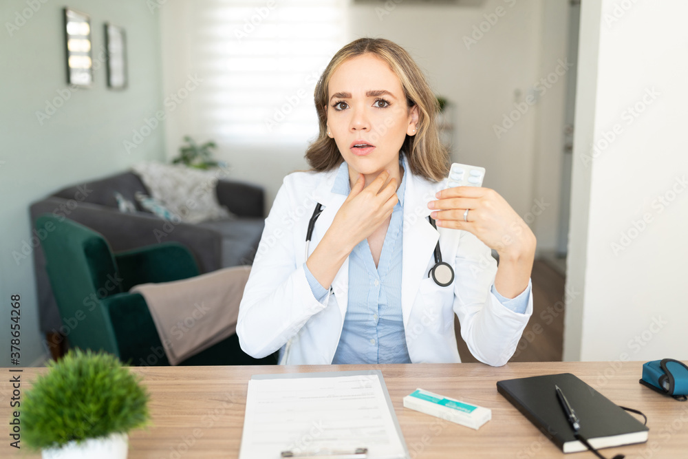 Female doctor talking about symptoms on video call Female doctor talking about symptoms on video call
