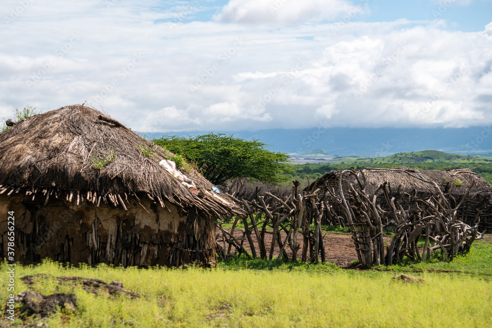 Traditional Maasai Village with Clay Round Huts in Engare Sero area near Lake Natron and Ol Doinyo Lengai volcano in Tanzania, Africa Traditional Maasai Village with Clay Round Huts in Engare Sero area near Lake Natron and Ol Doinyo Lengai volcano in Tanzania, Africa