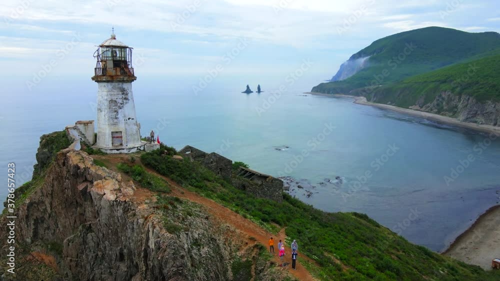 View from above. Flying over the picturesque Rudny lighthouse in the village of Rudnaya Pristan, Primorsky Territory. Landmark of Primorsky Krai View from above. Flying over the picturesque Rudny lighthouse in the village of Rudnaya Pristan, Primorsky Territory. Landmark of Primorsky Krai