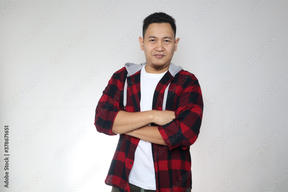 Portrait of happy young attractive cute Asian man smiling cheerfully, confident friendly gesture with arms crossed Portrait of happy young attractive cute Asian man smiling cheerfully, confident friendly gesture with arms crossed