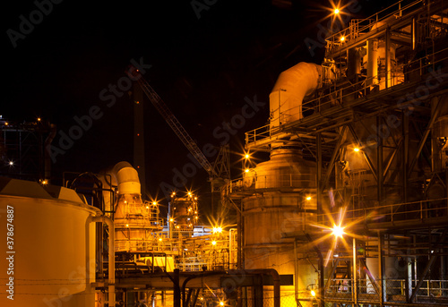 Mount Isa Mine Processing Plant. Industrial sulphuric acid plant containing 3 stage catalytic conversion, gas cleaning and drying towers, Copper Smelting. Illuminated night shot of acid plant.
