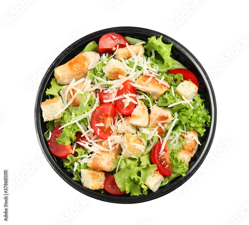 Delicious fresh salad in plastic container on white background, top view