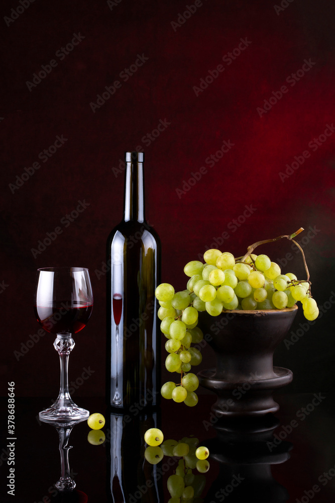 Still life with grapes and wine in glasses