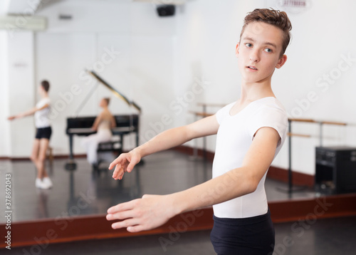 Young efficient dancer exercising in ballroom. High quality photo