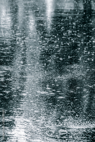 raindrop on wet asphalt pavement. rainy day in the city