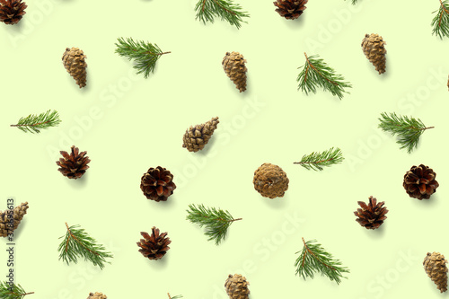 Pine cone Christmas background on green. Pine branches and cones. minimal creative cone arrangement pattern. flat lay, Modern christmas Background.