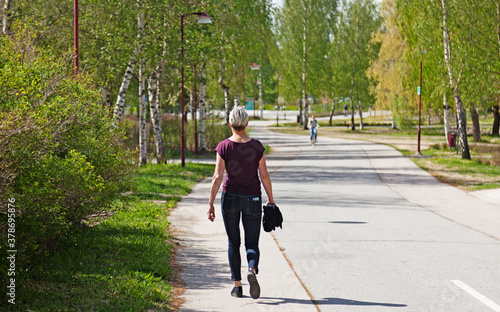 Umea, Norrland Sweden - July 2, 2020: mature woman walking near the university